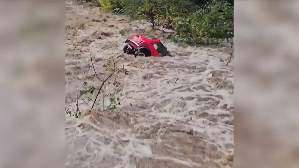 Video shot on Thursday shows a Mini Cooper being swept away by powerful floods in Saint-Marcel-les-Annonay, France.