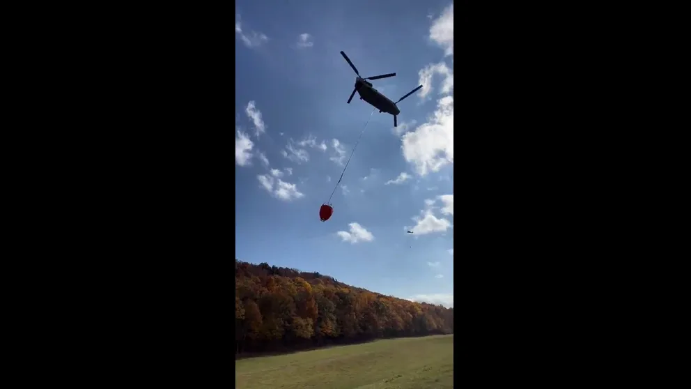 A video shared by the Connecticut National Guard shows a helicopter racing to the scene of the Hawthorne Fire to dump water on the flames as dry conditions persist in the region.