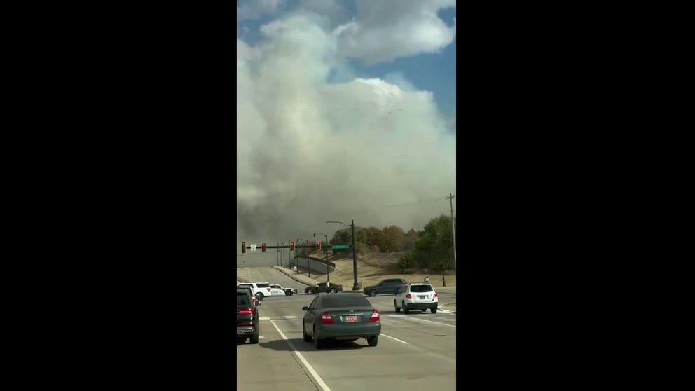 Video taken by a driver in Edmond, Oklahoma, shows thick smoke rising from a wildfire on Tuesday afternoon.