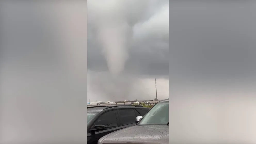 A video shot on Thursday shows a group of people at Mikeska's Bar-B-Q in El Campo, Texas, scrambling to see an apparent tornado across the highway. 