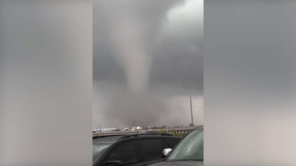 A video shot on Thursday shows a group of people at Mikeska's Bar-B-Q in El Campo, Texas, scrambling to see an apparent tornado across the highway. 