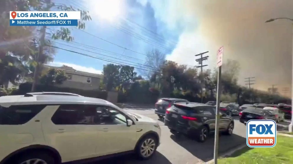 Video from FOX 11 Los Angeles shows the smoke from the Palisades Fire and traffic heading toward the explosive blaze. 