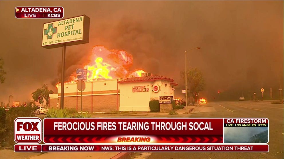 Video shows huge flames and thick smoke pouring from an auto repair business in Altadena, California, as the Eaton Wildfire consumes the landscape.