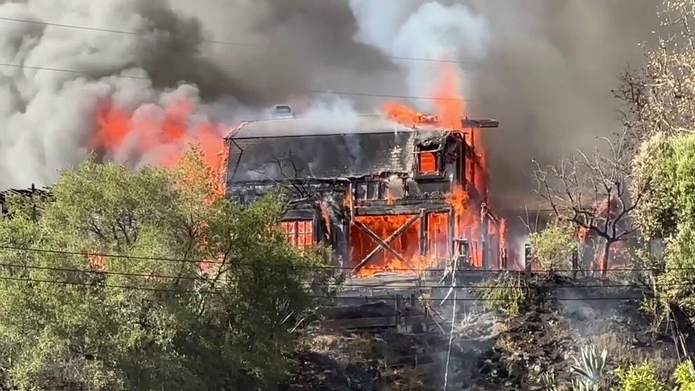 Shifting winds have caused the Palisades Fire in Southern California to spread eastward, threatening homes in the neighborhood of Mandeville Canyon.