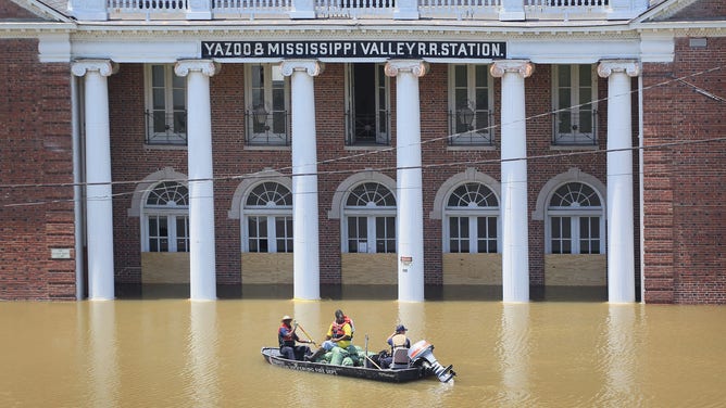 City workers transport a load of sandbags to be used in re-enforcing a levee gate past the Yazoo &amp; Mississippi Valley Railroad Station May 11, 2011 in Vicksburg, Mississippi.