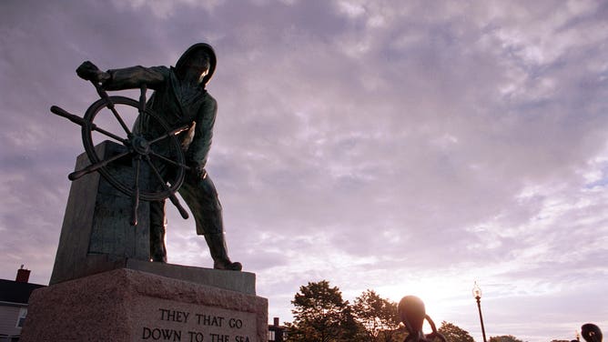 The sun rises over the fisherman's memorial in Gloucester, MA. 