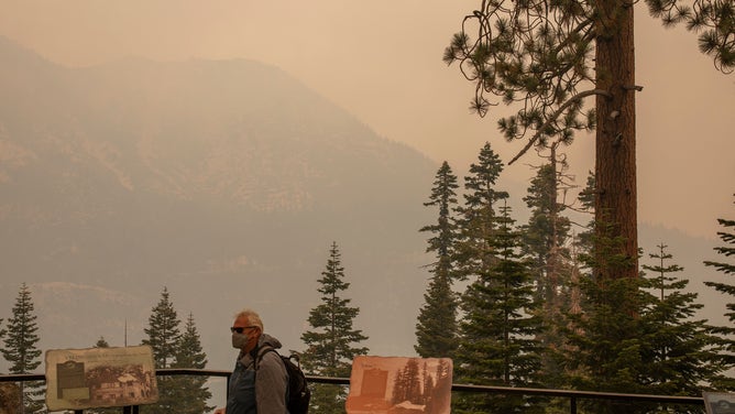 Smoke and haze from the Dixie Fire hang over the skyline on August 17, 2021 in South Lake Tahoe, California.