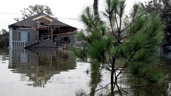A two-story home covered by flood waters after Hurricane Katrina in 2005.