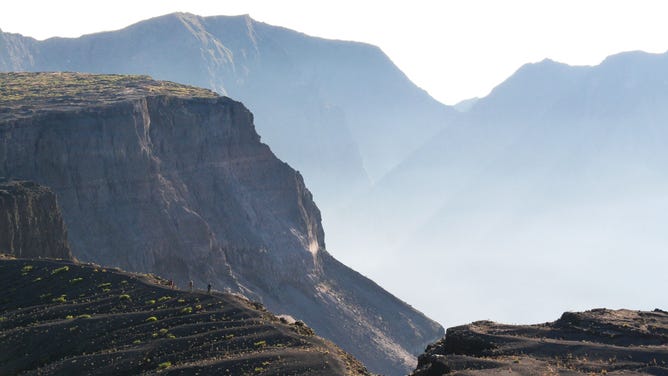 People walk along the craters edge of Mount Tambora on the island of Sumbawa in Indonesia.