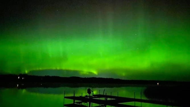 Green lights over a lake