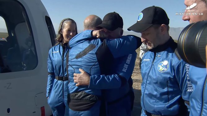 William Shatner gets his astronaut wings from Jeff Bezos and a hug after his spaceflight on Oct. 13, 2021.