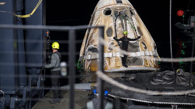 Support teams work around the SpaceX Crew Dragon Endeavour spacecraft shortly after it landed with NASA astronauts