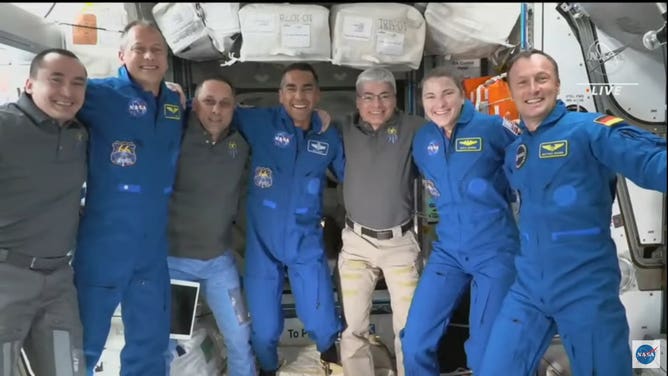 Astronauts pose for photo on space station