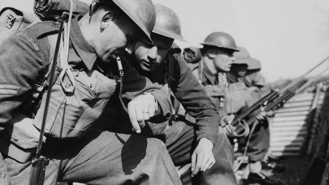 Grenadier Guards of the British Army check the time while on the lines.