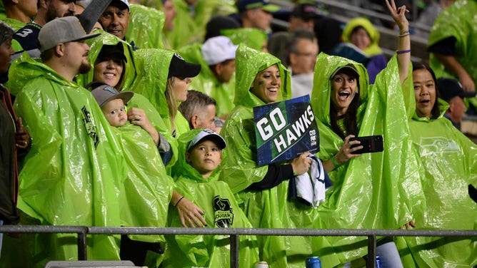 Seattle fans don't let a little rain dampen their spirits during a preseason game between the Oakland Raiders and the Seattle Seahawks on August 29, 2019 at Century Link Stadium in Seattle, WA.