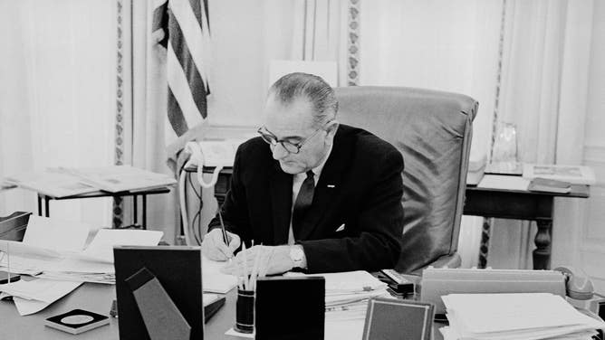 President Lyndon B. Johnson working in the Oval Office at the White House. Johnson signed the Uniform Time Act into law in 1966.