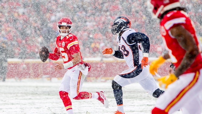 Kansas City Chiefs quarterback Patrick Mahomes looks toward Kansas City Chiefs Wide Receiver Demarcus Robinson while scrambling in snowy conditions during the game between the Denver Broncos and the Kansas City Chiefs on Sunday December 15, 2019 at Arrowhead Stadium in Kansas City, MO.