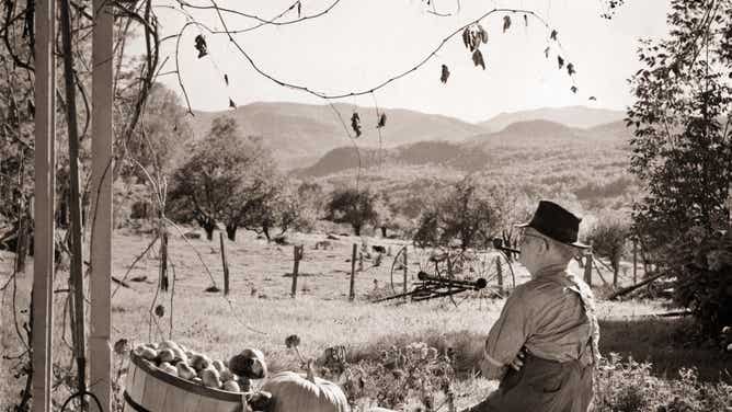 A farmer sits on his porch on an autumn day.