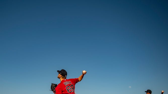 Tanner Houck #89 and Matt Barnes #32 of the Boston Red Sox throw during the MGM Sox at Sundown spring training at Fenway South in Fort Myers, Florida.