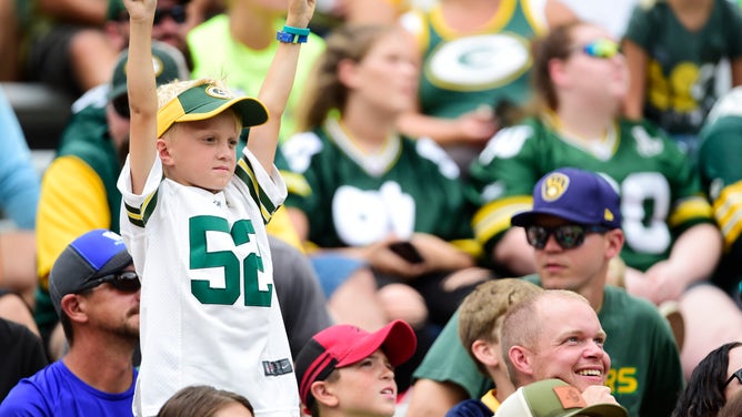 A young Green Bay Packers fan cheers against the New York Jets at Lambeau Field in Green Bay, Wisconsin.a
