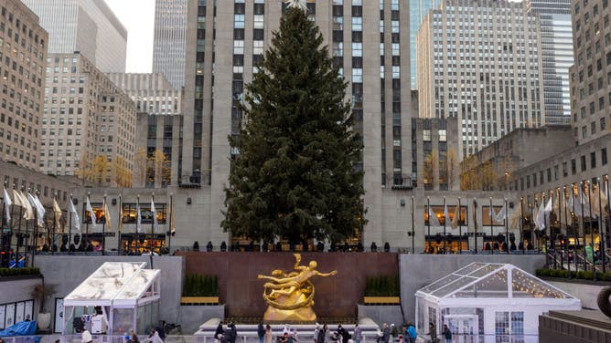 People ice skate at Rockefeller Center on November 28, 2021 in New York City. The holiday season is expected to return to bigger than last year with events like the Rockefeller Christmas Tree Lighting and New Year’s Eve returning with spectators, (Photo by Alexi Rosenfeld/Getty Images)