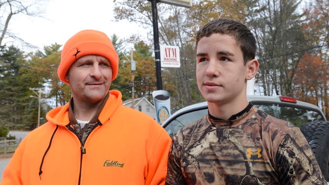 Father and son prepare to hunt in Sebago, Maine.