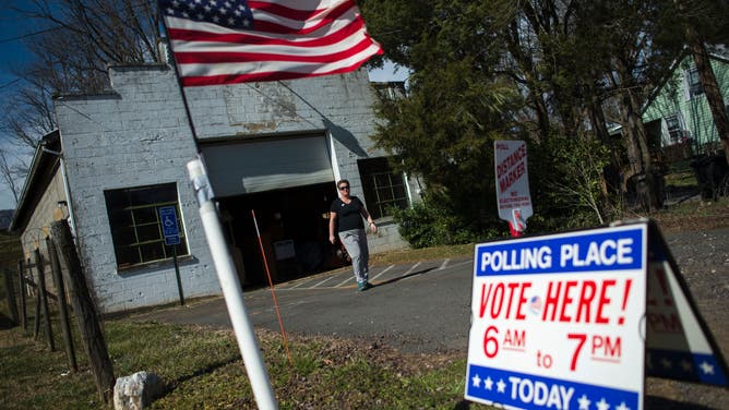 A flag flies in front of the Old Etlan rescue squad building, used as a county voting location in Etlan, Virginia during the 2016 Super Tuesday primary voting.