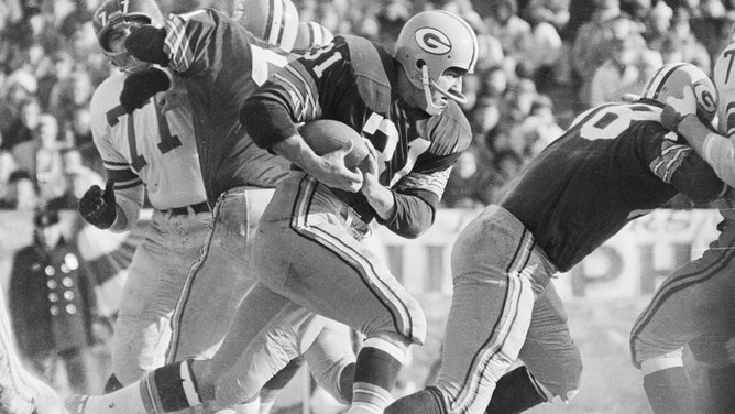 Jim Taylor of Green Bay goes through the line against the New York Giants during the 1961 NFL Championships. The Packers went on to defeat the Giants 37-0.