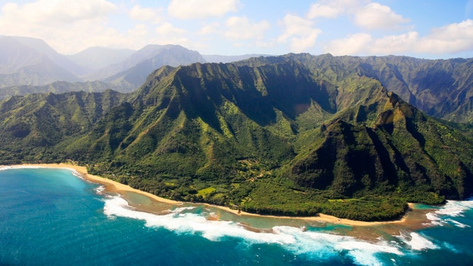 The sun shines on the Napali Coast on the island of Kauai in Hawaii.