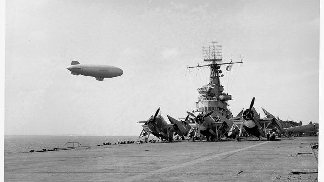 An anti-sub coastal blimp drifts above the U.S. Navy's USS Ranger in March 1943.