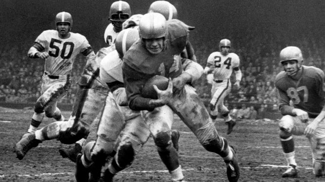 Detroit Lions back Bob Hoernschemeyer on a carry. The Lions went on to win 17-16 against the Cleveland Browns in a League Championship game on December 27, 1953 in Detroit, Michigan.
