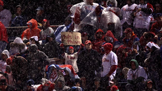A young fan of the Philadelphia Phillies holds up a sign which reads "Phils in Phive" as rain falls against the Tampa Bay Rays during Game 5 of the 2008 MLB World Series.