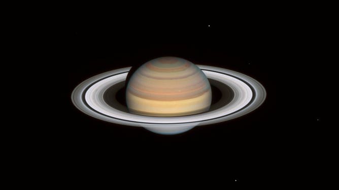 Hubble’s new look at Saturn on 12 September 2021 shows rapid and extreme colour changes in the bands in the planet’s northern hemisphere, where it is now early autumn. The bands have varied throughout Hubble observations in both 2019 and 2020. Hubble’s Saturn image catches the planet following the southern hemisphere’s winter, evident in the lingering blue-ish hue of the south pole.