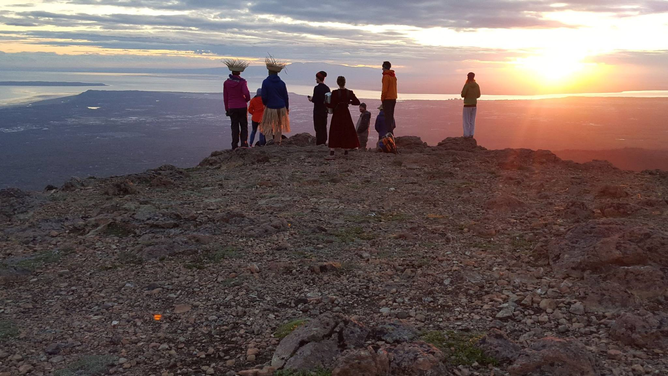 The sun is still above the horizon at midnight on the summer solstice, as viewed from the summit of Flattop Mountain just east of Anchorage, Alaska.