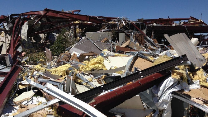 This photo shows EF-3 damage to a metal and steel building just north of Interstate 40, or about 5 miles east-southeast of El Reno, Oklahoma, in Canadian County. A progressive collapse of rigid frames occurred with the metal and steel building.