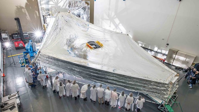 Webb's Sunshield test unit stacked and expanded at a cleanroom in the Northrop Grumman facility in Redondo Beach, California.