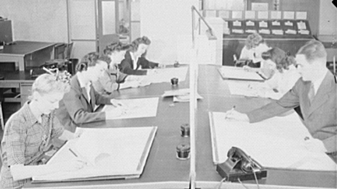 The U.S. Weather Bureau station at the National Airport. Weather observation data from all sections of the country being placed on charts and maps preparatory to the issuing of forecasts.