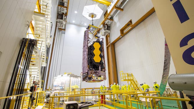 The James Webb Space Telescope is lifted up inside the cleanroom to be placed on top of the rocket. (Image credit: ESA-M.Pedoussaut)