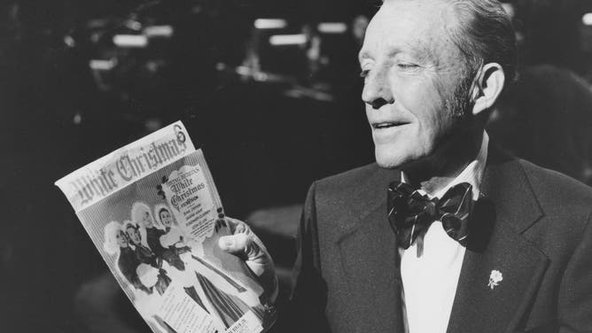 In 1975, Bing Crosby holds a poster for the 1954 film "White Christmas". The movie was another project where Crosby worked with Berlin.