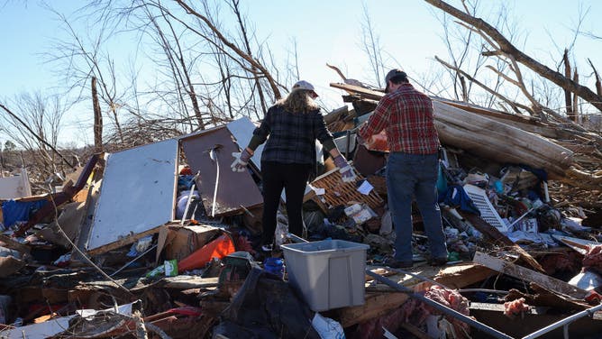 People are seen amid rubbles after tornadoes hit Dawson Springs, Kentucky, United States on December 13, 2021.