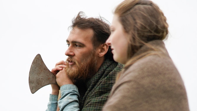 Two Viking re-enactors share a moment together.