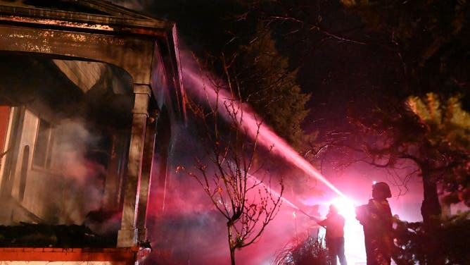 Fire crew work to put out flames at a home burnt in the Marshall Fire in Boulder County on December 31, 2021 in Louisville, Colorado. (Photo by RJ Sangosti/MediaNews Group/The Denver Post via Getty Images)
