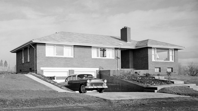 A Chevrolet automobile in the driveway of a new suburban home in Washington state. 