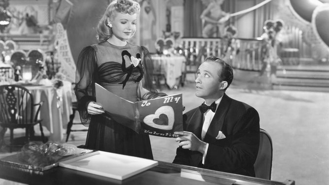 In the 1942 film "Holiday Inn," Linda Mason (Marjorie Reynolds) joins Jim Hardy (Bing Crosby) at the piano to look at a Valentine in the Holiday Inn.
