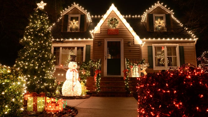 A house outlined with white Christmas lights and lawn ornaments in New Jersey.