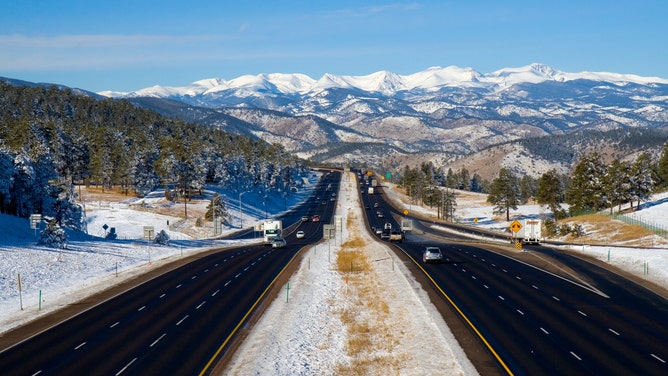 Snow covers the landscape surrounding I-75 facing west toward the Rocky Mountains.