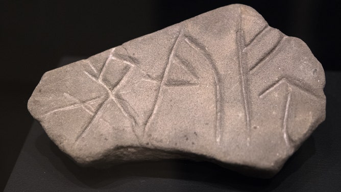 A whetstone with Viking rune carvings. While a select few could read runic inscriptions during the Viking Age, most of Viking society was unable to read them.