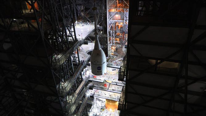 The Orion spacecraft is stacked on top of the SLS inside the VAB.