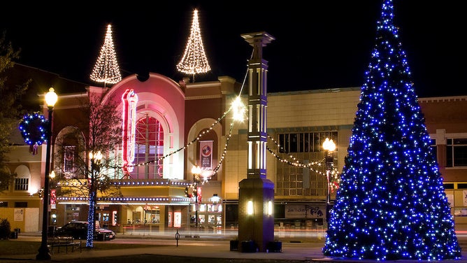 Two rooftop trees sparkle on top of the movie theater in Knoxville, TN.