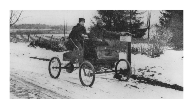 A postman, or Rural Free Delivery (RFD) carrier, tries out a car on his snowy route. Because of the conditions of rural post roads, most postmen used horses, wagons, and sleds to deliver mail on rural roads.